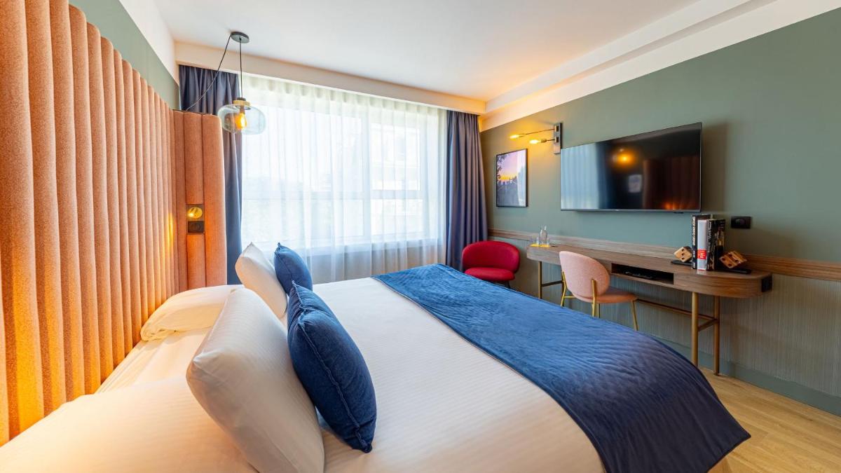 Un ou plusieurs lits dans un hébergement de l'établissement Le Riviera - Hôtel Restaurant & Spa - Ex Golden Tulip Aix les bains