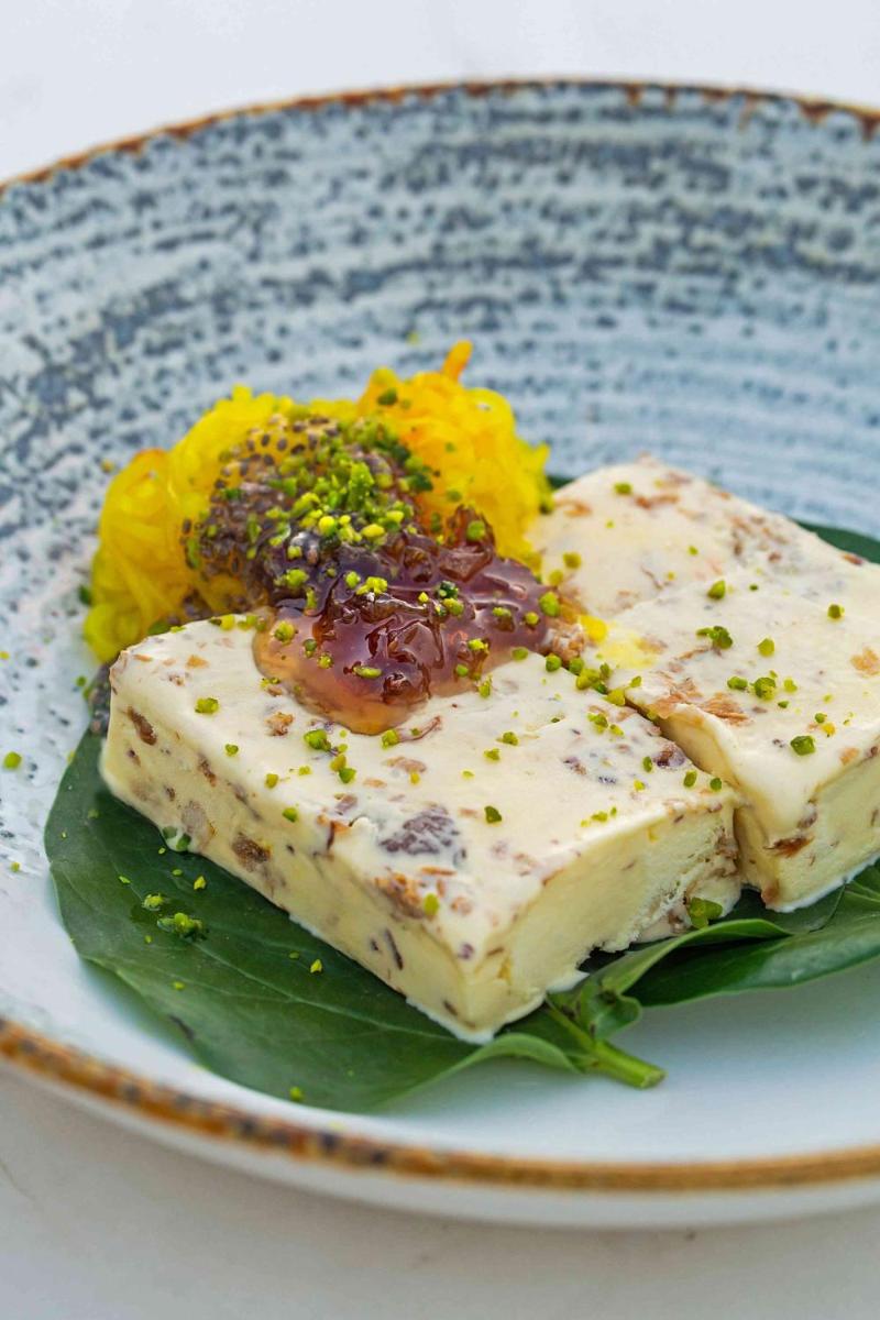 two pieces of tofu on a plate with flowers at Hyatt Regency Jaipur Mansarovar in Jaipur two pieces of tofu on a plate with flowers at Hyatt Regency Jaipur Mansarovar in Jaipur