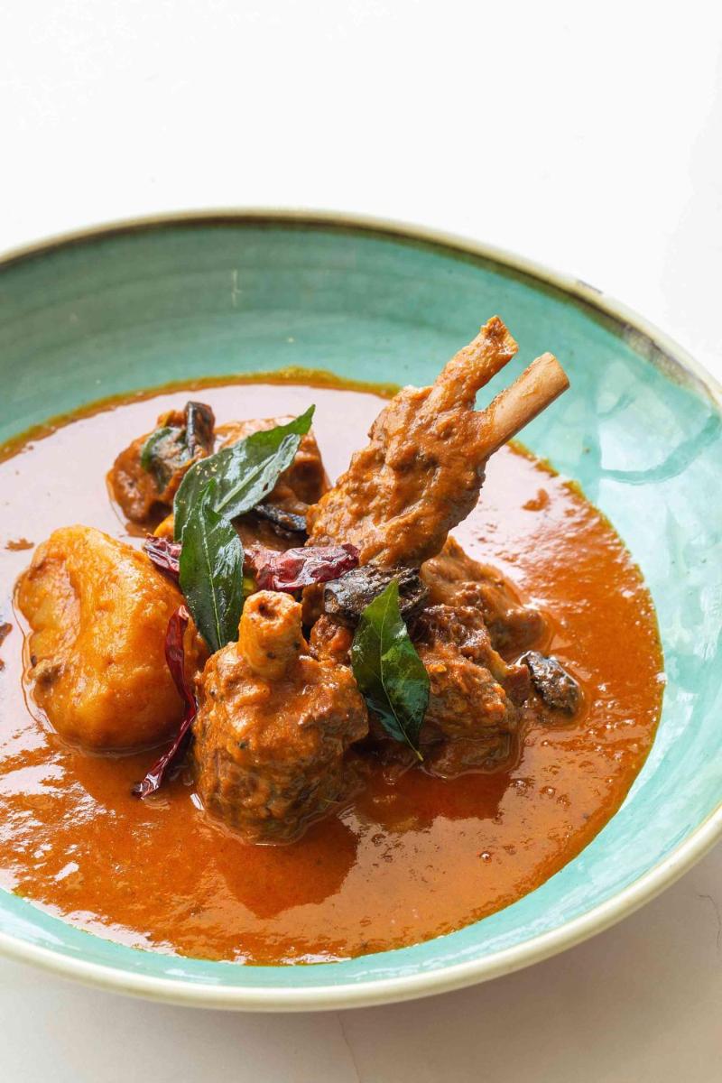 a plate of food with meat and sauce at Hyatt Regency Jaipur Mansarovar in Jaipur a plate of food with meat and sauce at Hyatt Regency Jaipur Mansarovar in Jaipur