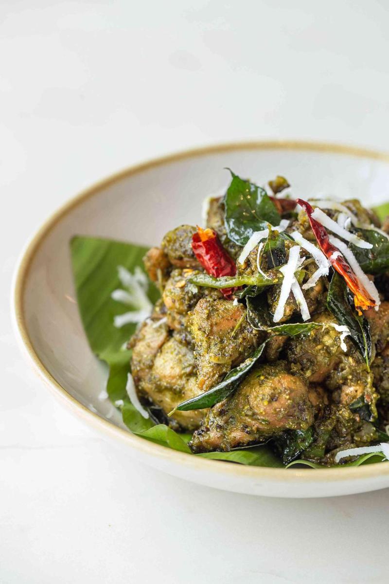 a white bowl filled with food on top of greens at Hyatt Regency Jaipur Mansarovar in Jaipur a white bowl filled with food on top of greens at Hyatt Regency Jaipur Mansarovar in Jaipur