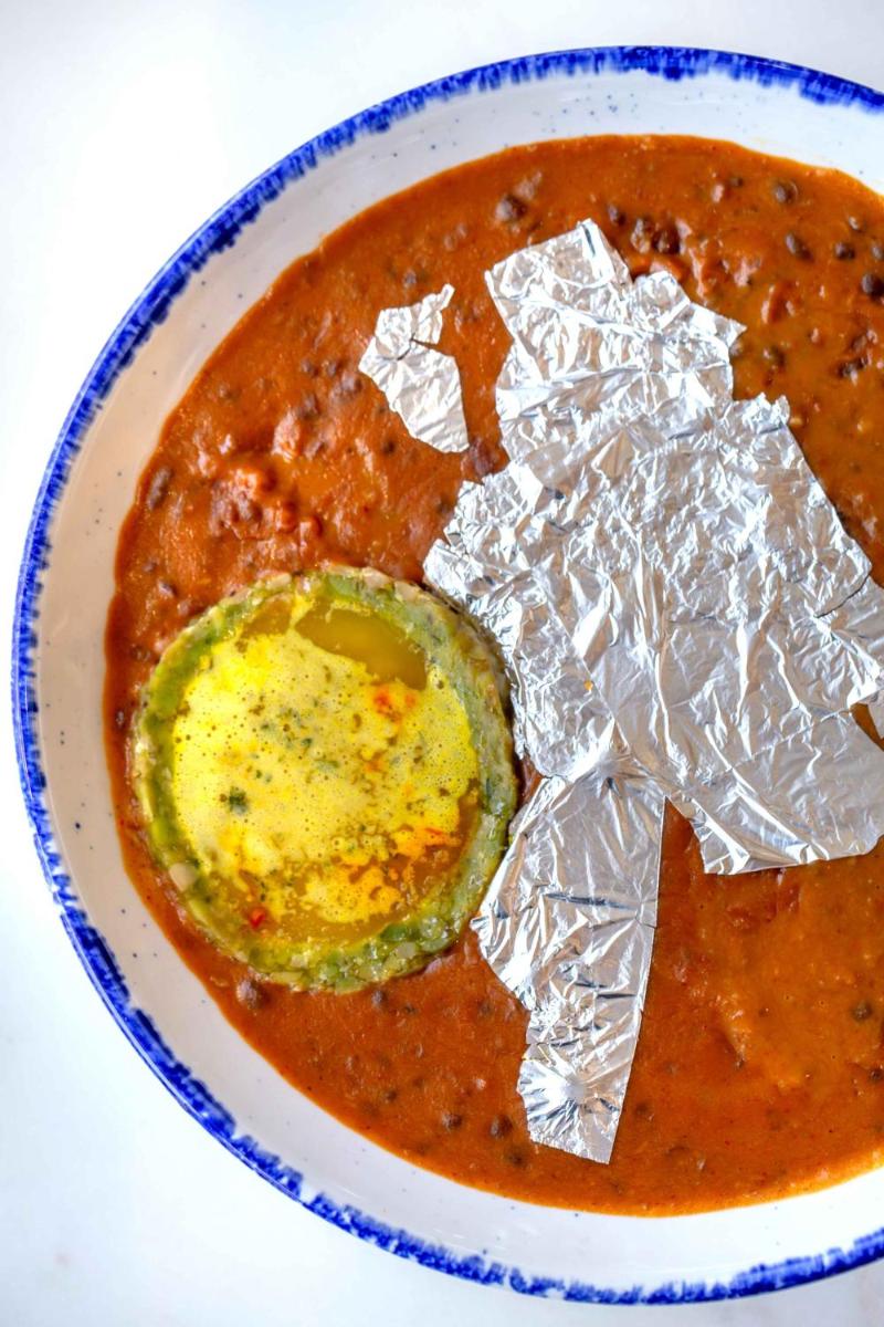 a bowl of tomato soup with a pickle and tin foil at Hyatt Regency Jaipur Mansarovar in Jaipur a bowl of tomato soup with a pickle and tin foil at Hyatt Regency Jaipur Mansarovar in Jaipur