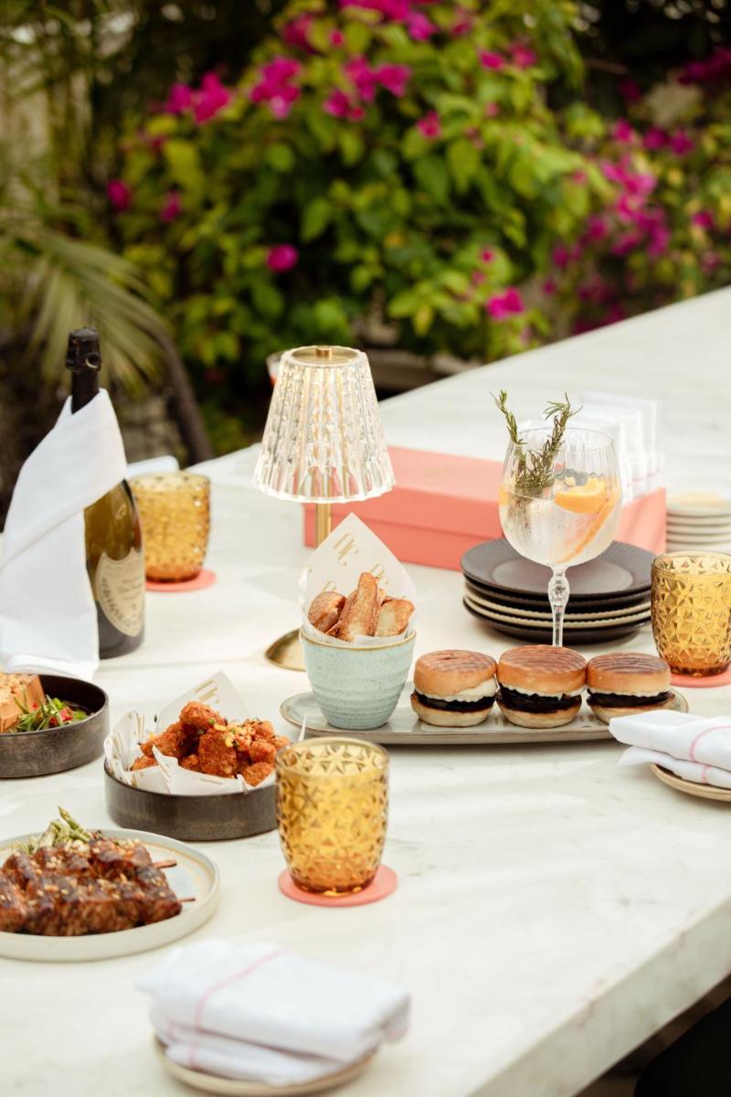 a table topped with plates of food and drinks at Hyatt Regency Jaipur Mansarovar in Jaipur a table topped with plates of food and drinks at Hyatt Regency Jaipur Mansarovar in Jaipur