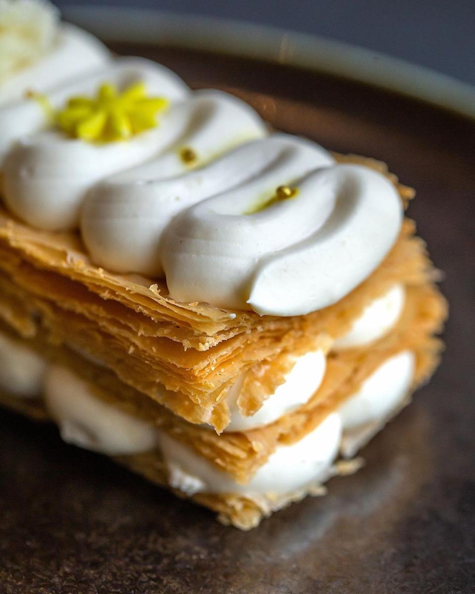 a pastry with white frosting and a flower on it at Hyatt Regency Jaipur Mansarovar in Jaipur a pastry with white frosting and a flower on it at Hyatt Regency Jaipur Mansarovar in Jaipur
