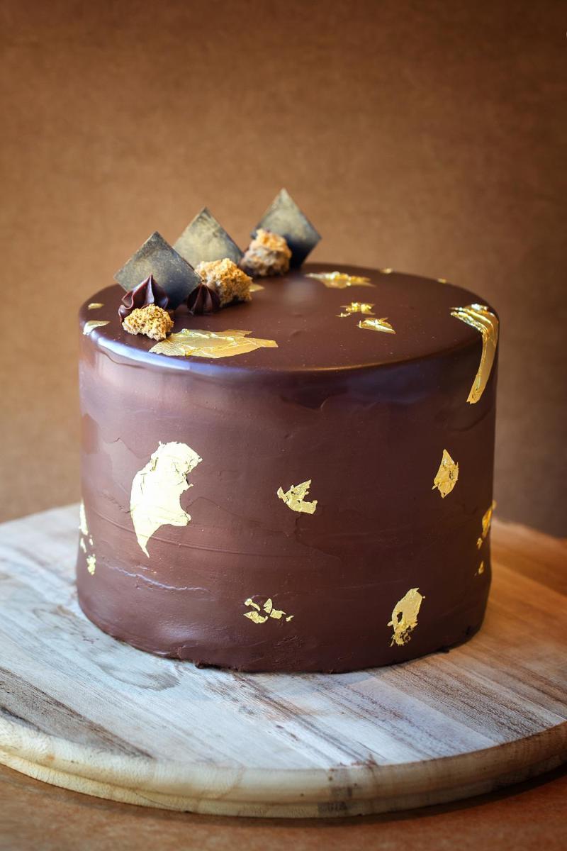 a chocolate cake on a plate on a table at Hyatt Regency Jaipur Mansarovar in Jaipur a chocolate cake on a plate on a table at Hyatt Regency Jaipur Mansarovar in Jaipur