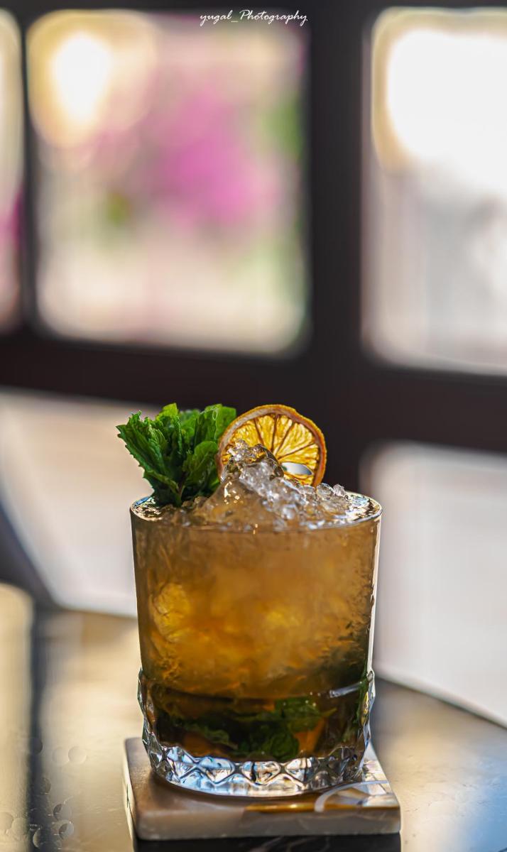 a drink with an orange slice on a table at Hyatt Regency Jaipur Mansarovar in Jaipur a drink with an orange slice on a table at Hyatt Regency Jaipur Mansarovar in Jaipur