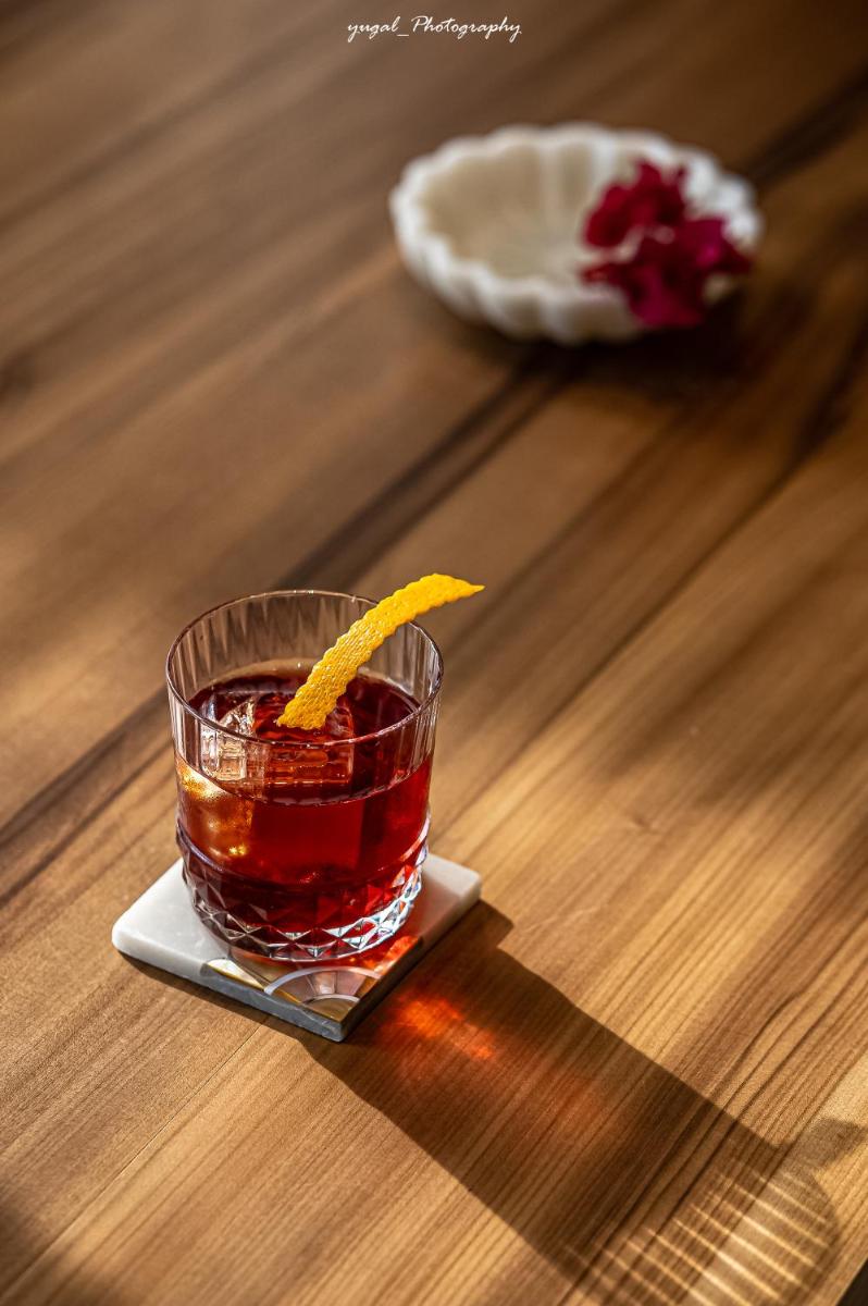 a drink with an orange slice in a glass on a table at Hyatt Regency Jaipur Mansarovar in Jaipur a drink with an orange slice in a glass on a table at Hyatt Regency Jaipur Mansarovar in Jaipur