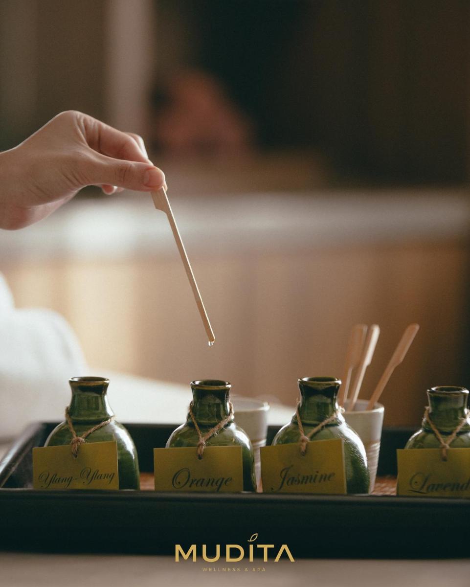 a person holding a chopstick in front of bottles at Hyatt Regency Jaipur Mansarovar in Jaipur a person holding a chopstick in front of bottles at Hyatt Regency Jaipur Mansarovar in Jaipur
