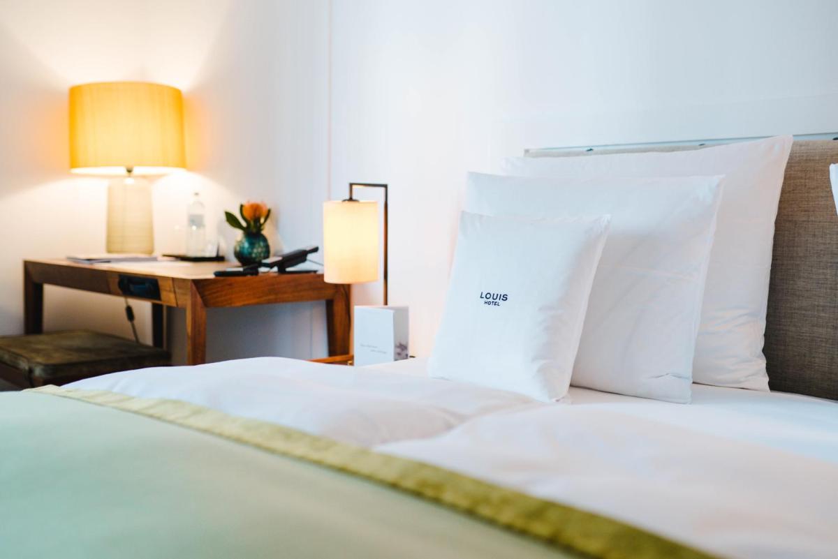 Ein Bett oder Betten in einem Zimmer der Unterkunft Louis Hotel Ein Bett oder Betten in einem Zimmer der Unterkunft Louis Hotel