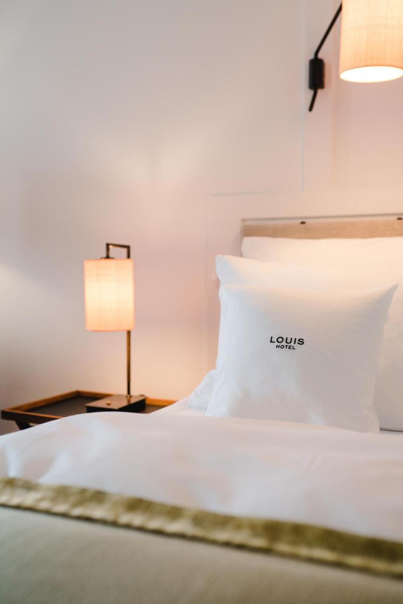 Ein Bett oder Betten in einem Zimmer der Unterkunft Louis Hotel Ein Bett oder Betten in einem Zimmer der Unterkunft Louis Hotel