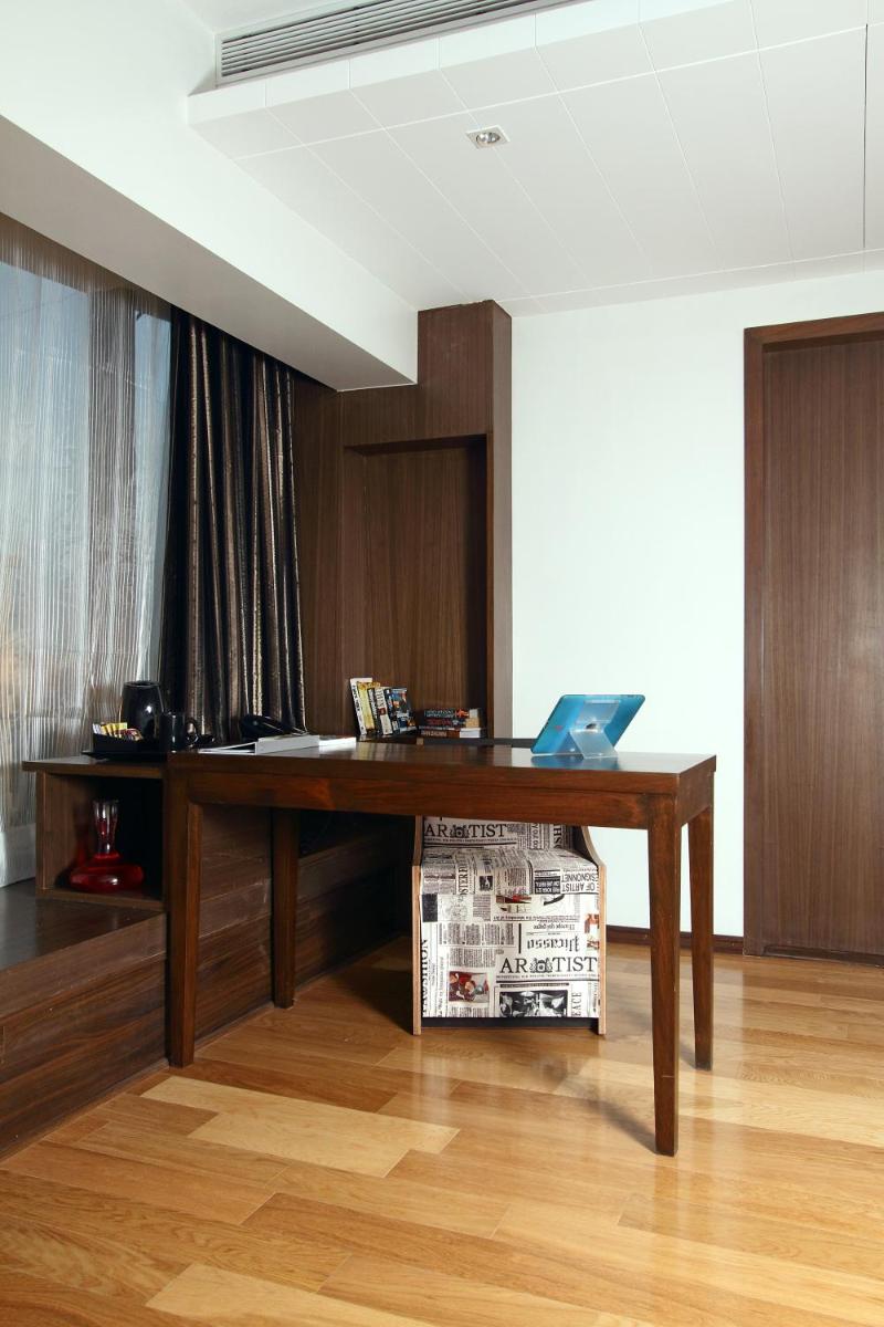 a wooden desk with a laptop on top of it at Svenska Design Hotel in Mumbai