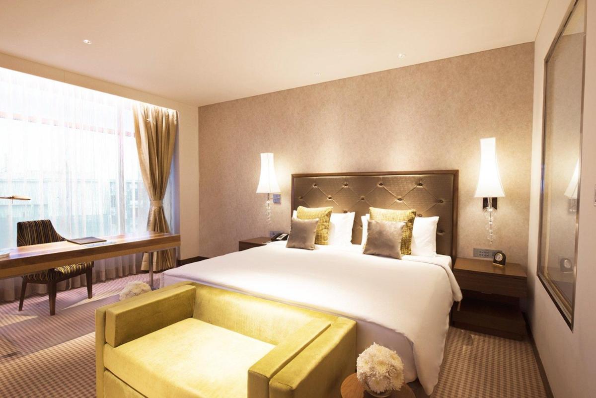 a hotel room with a large bed and a desk at Taj Swarna, Amritsar in Amritsar +27 photos