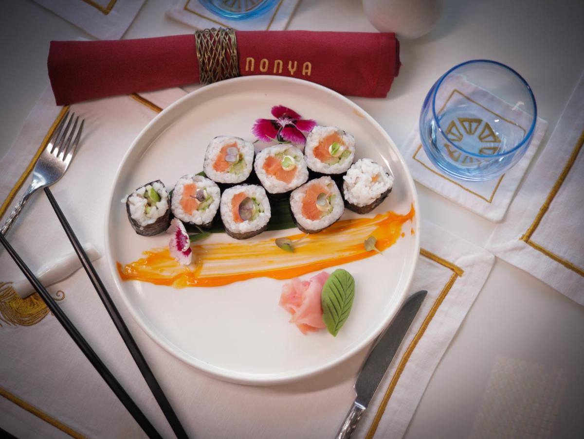 a plate of sushi on a table at Taj Skyline Ahmedabad in Ahmedabad