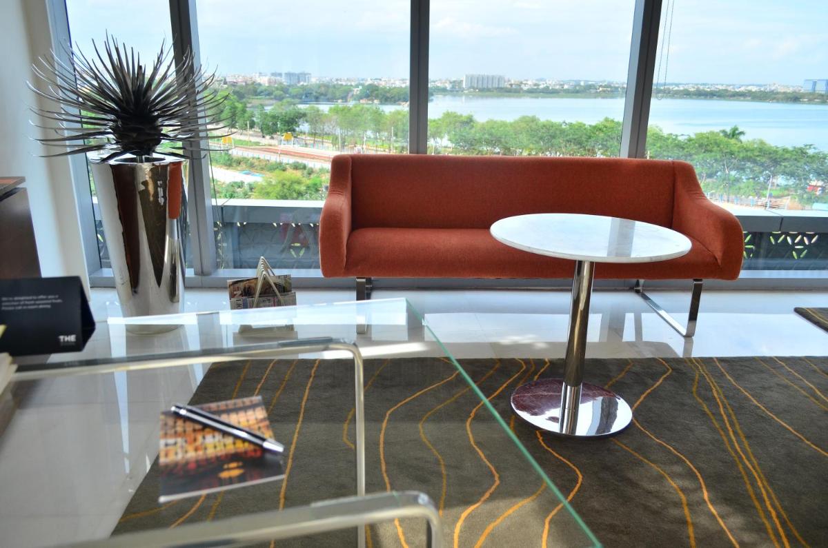 a living room with a couch and a table at The Park Hyderabad, Banjara Hills near Hussain Sagar Lake in Hyderabad a living room with a couch and a table at The Park Hyderabad, Banjara Hills near Hussain Sagar Lake in Hyderabad