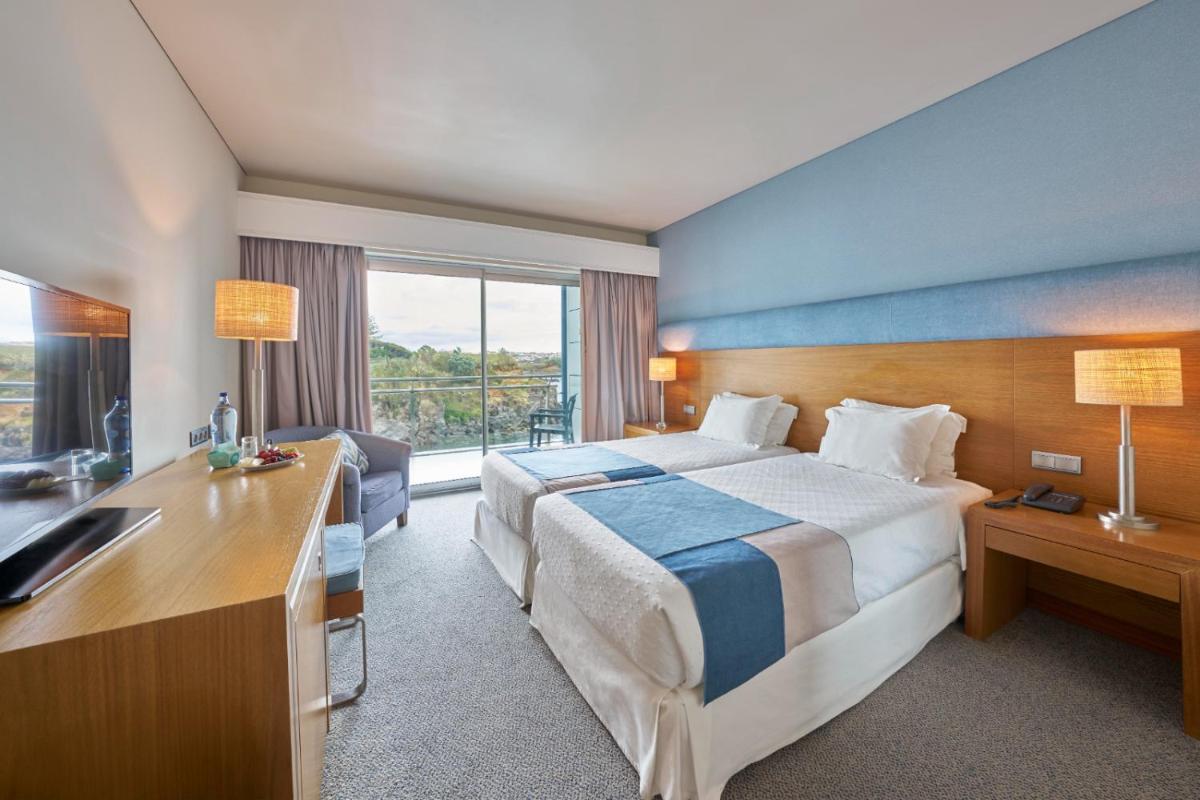 Uma cama ou camas num quarto em Hotel Do Caracol