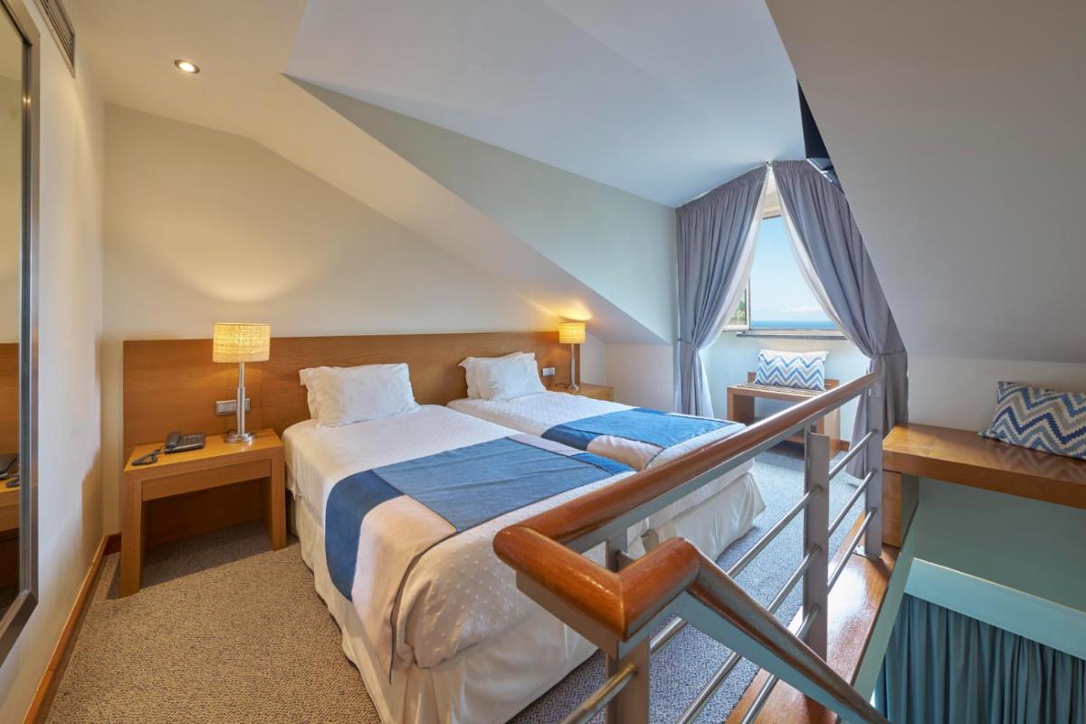 Uma cama ou camas num quarto em Hotel Do Caracol