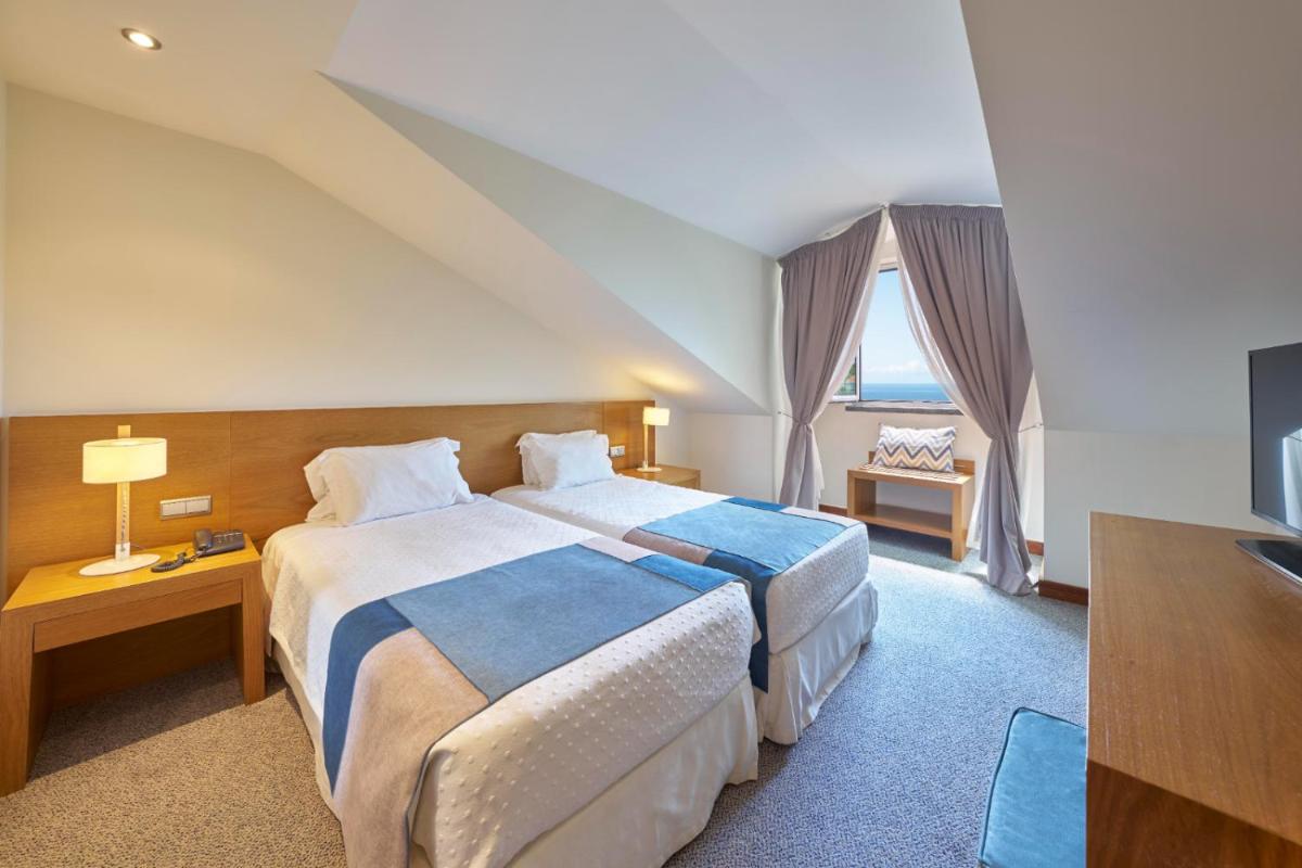 Uma cama ou camas num quarto em Hotel Do Caracol
