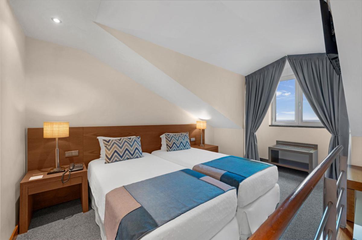 Uma cama ou camas num quarto em Hotel Do Caracol