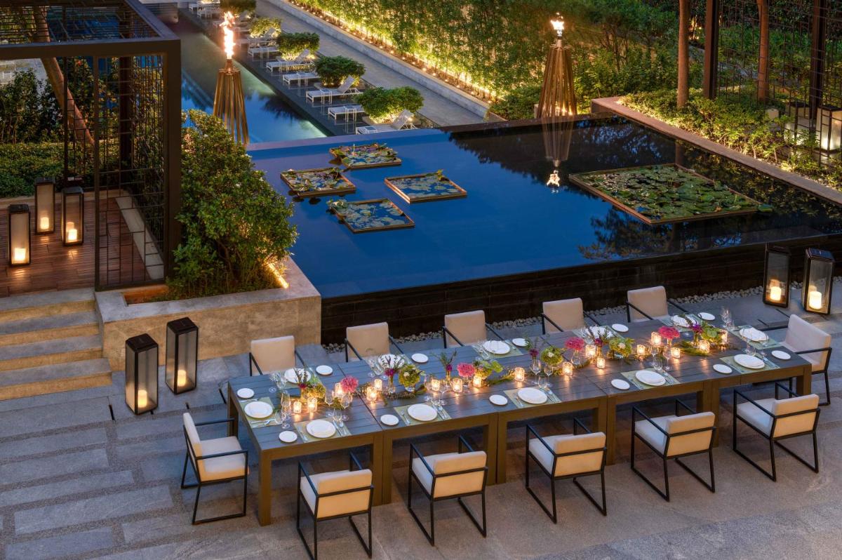 an overhead view of a table and chairs and a pool at Four Seasons Hotel Bengaluru at Embassy ONE in Bengaluru an overhead view of a table and chairs and a pool at Four Seasons Hotel Bengaluru at Embassy ONE in Bengaluru