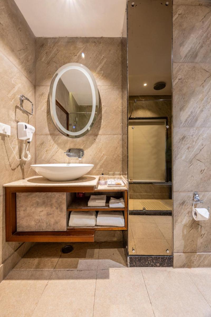 a bathroom with a sink and a mirror at Antalya By Divine Ganga Cottage in Rishīkesh