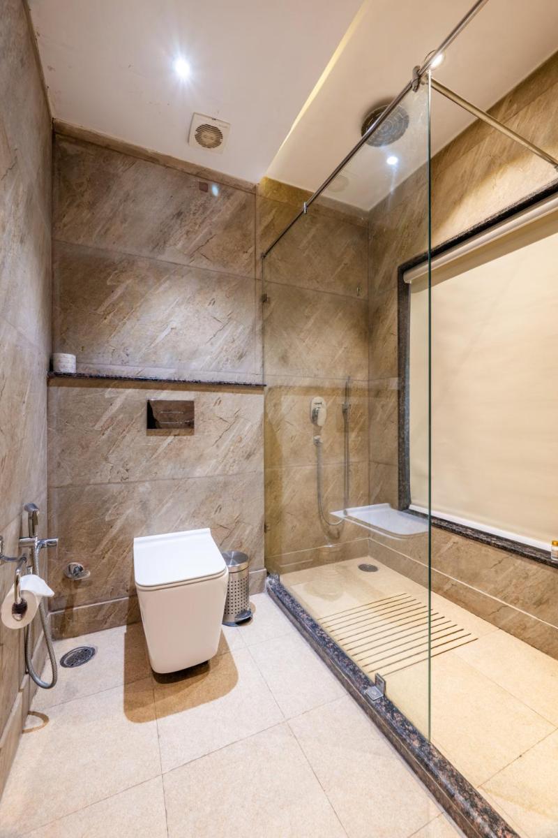 a bathroom with a glass shower and a toilet at Antalya By Divine Ganga Cottage in Rishīkesh