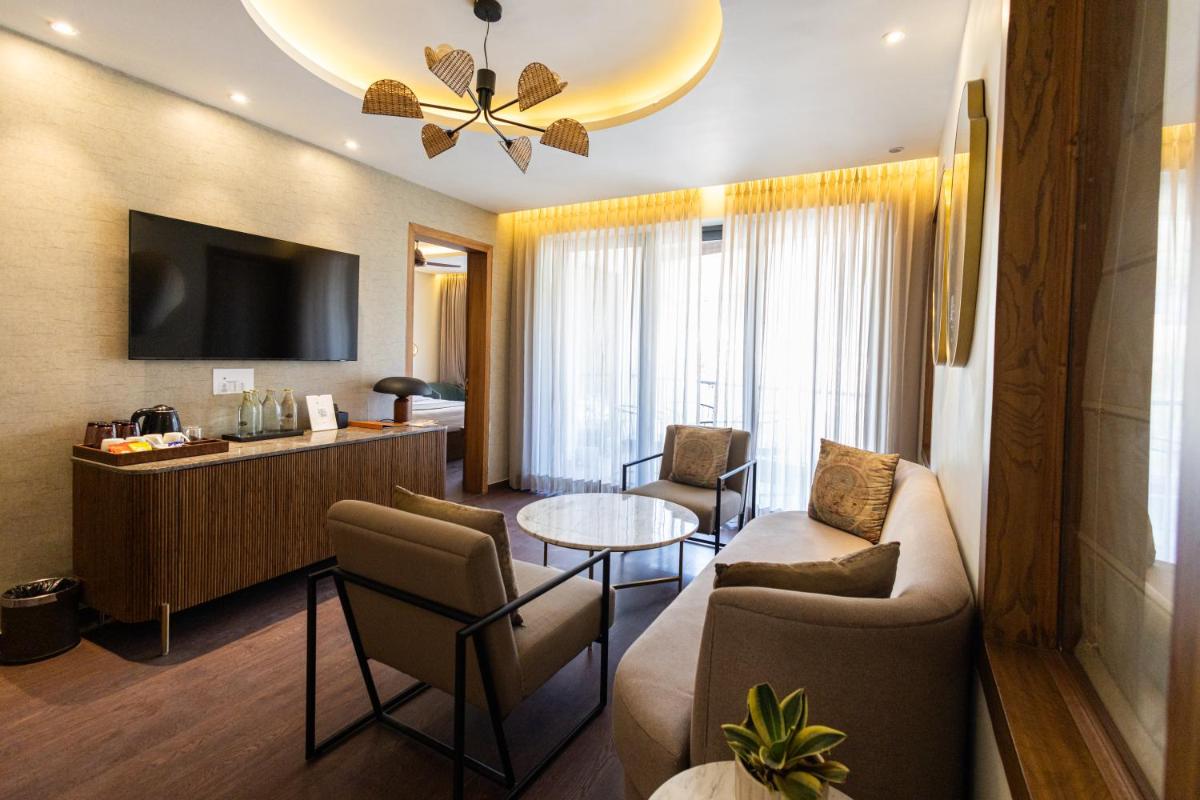a living room with a couch and a table at Antalya By Divine Ganga Cottage in Rishīkesh