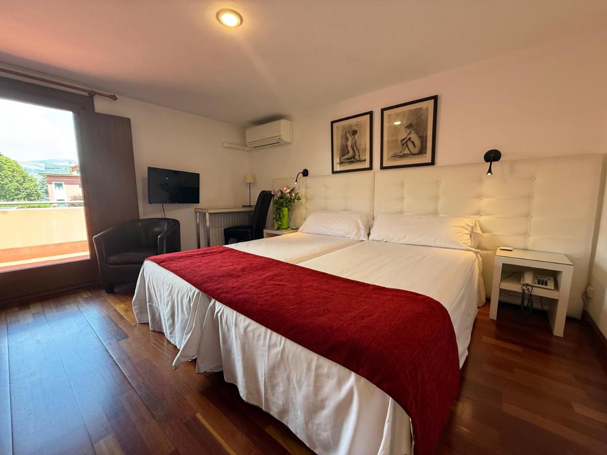 Cama o camas de una habitación en Hotel Del Lago