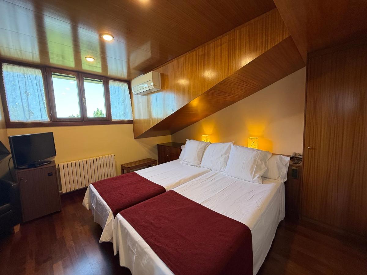 Cama o camas de una habitación en Hotel Del Lago