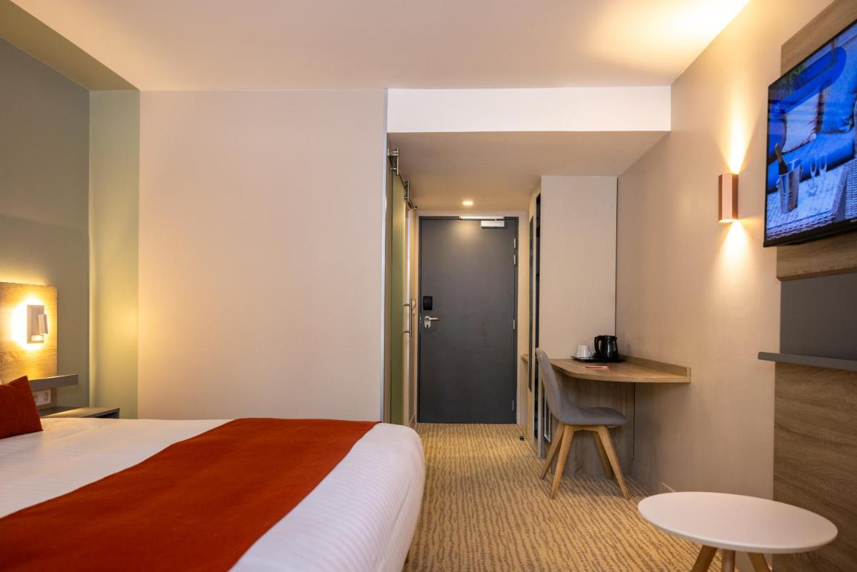 Un ou plusieurs lits dans un hébergement de l'établissement Hôtel & Spa Vitalparc, The Originals Collection