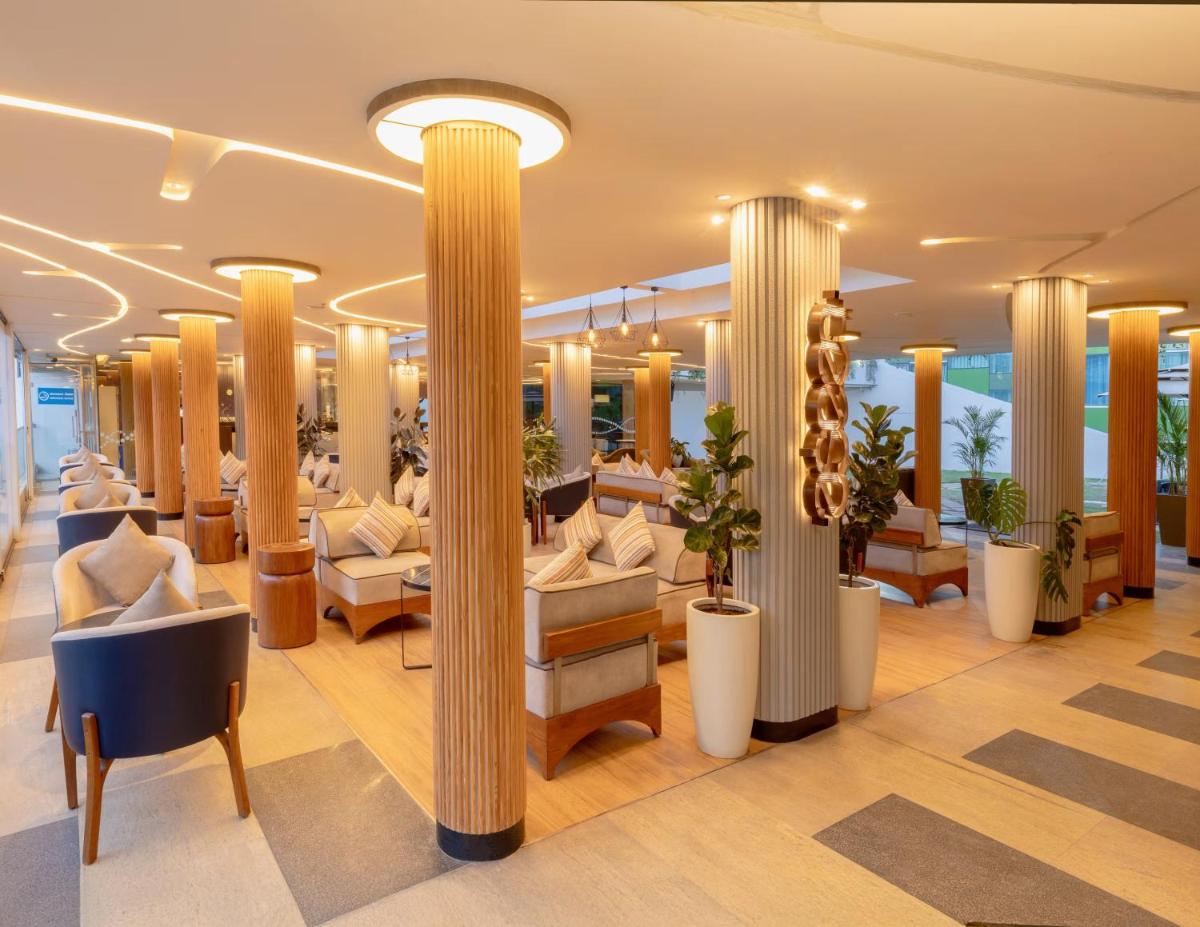 a lobby of a cruise ship with columns at Vivanta Bengaluru, Whitefield in Bengaluru
