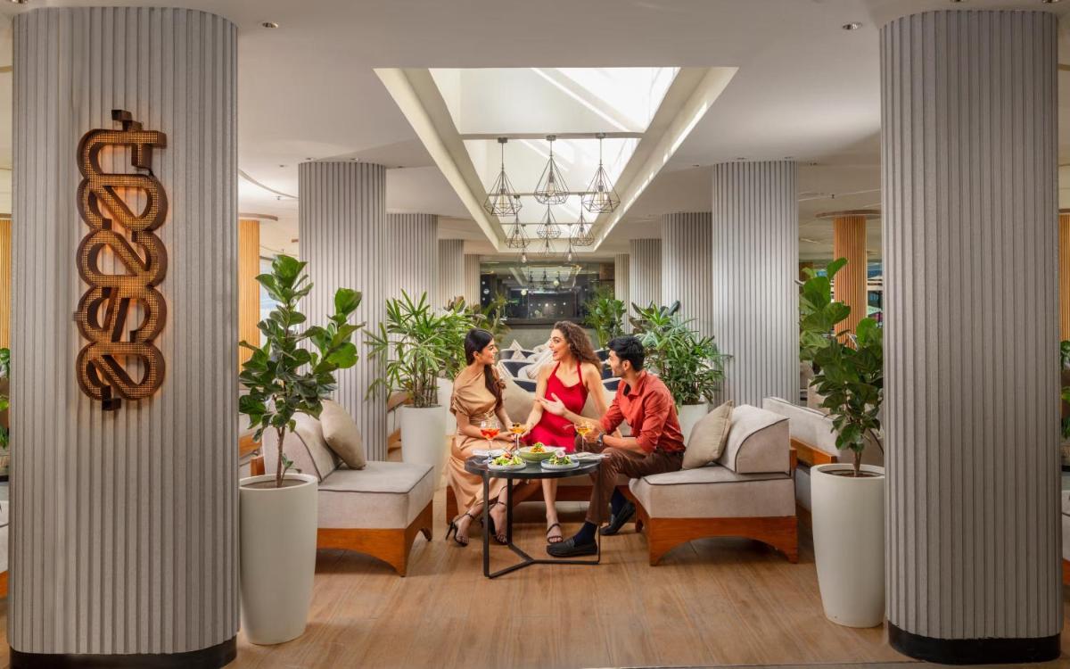 a group of people sitting around a table in a lobby at Vivanta Bengaluru, Whitefield in Bengaluru