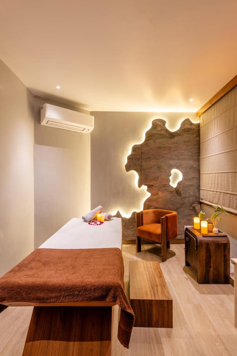 a bedroom with a bed and a chair and a desk at Antalya By Divine Ganga Cottage in Rishīkesh