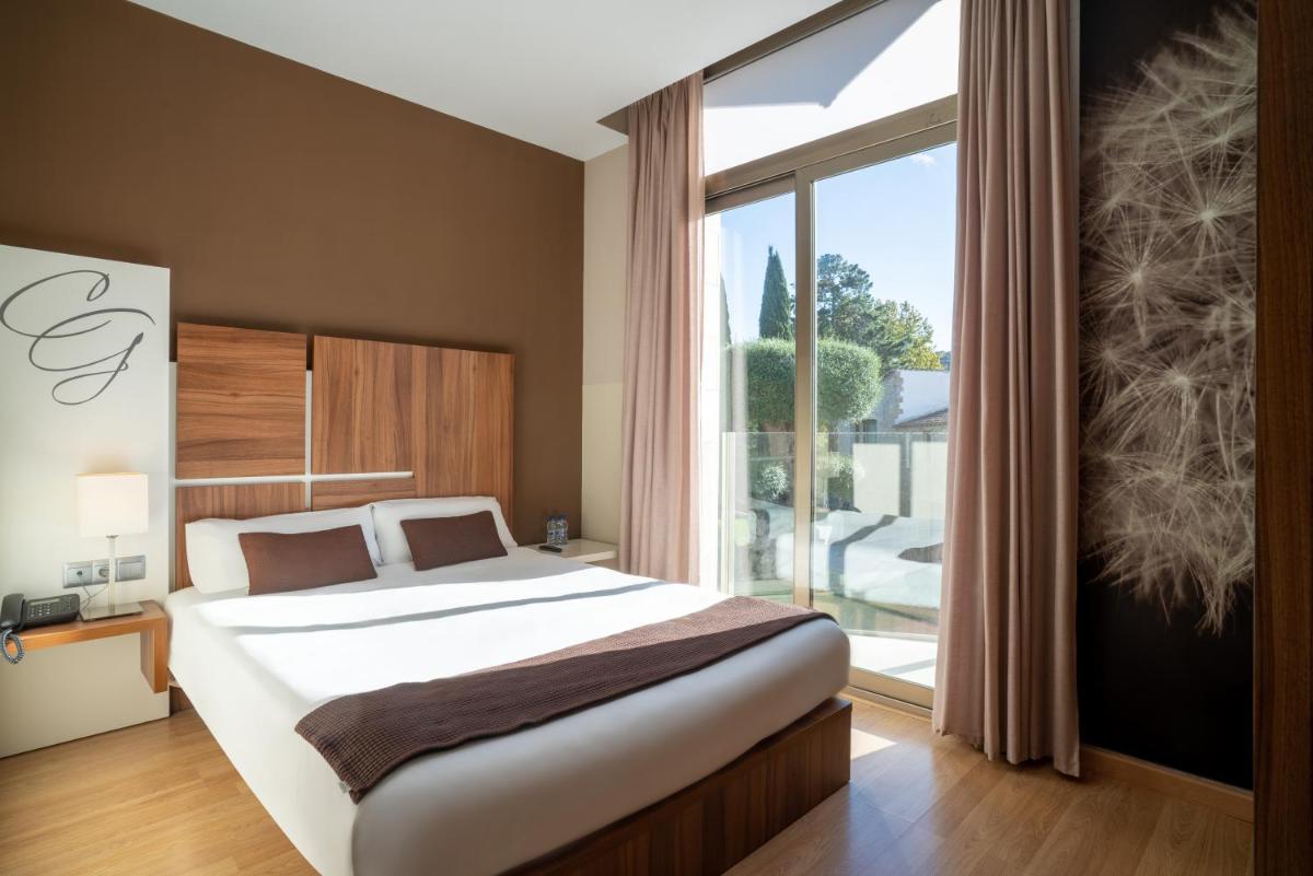 Cama o camas de una habitación en Hotel & Spa Golden Barcelona