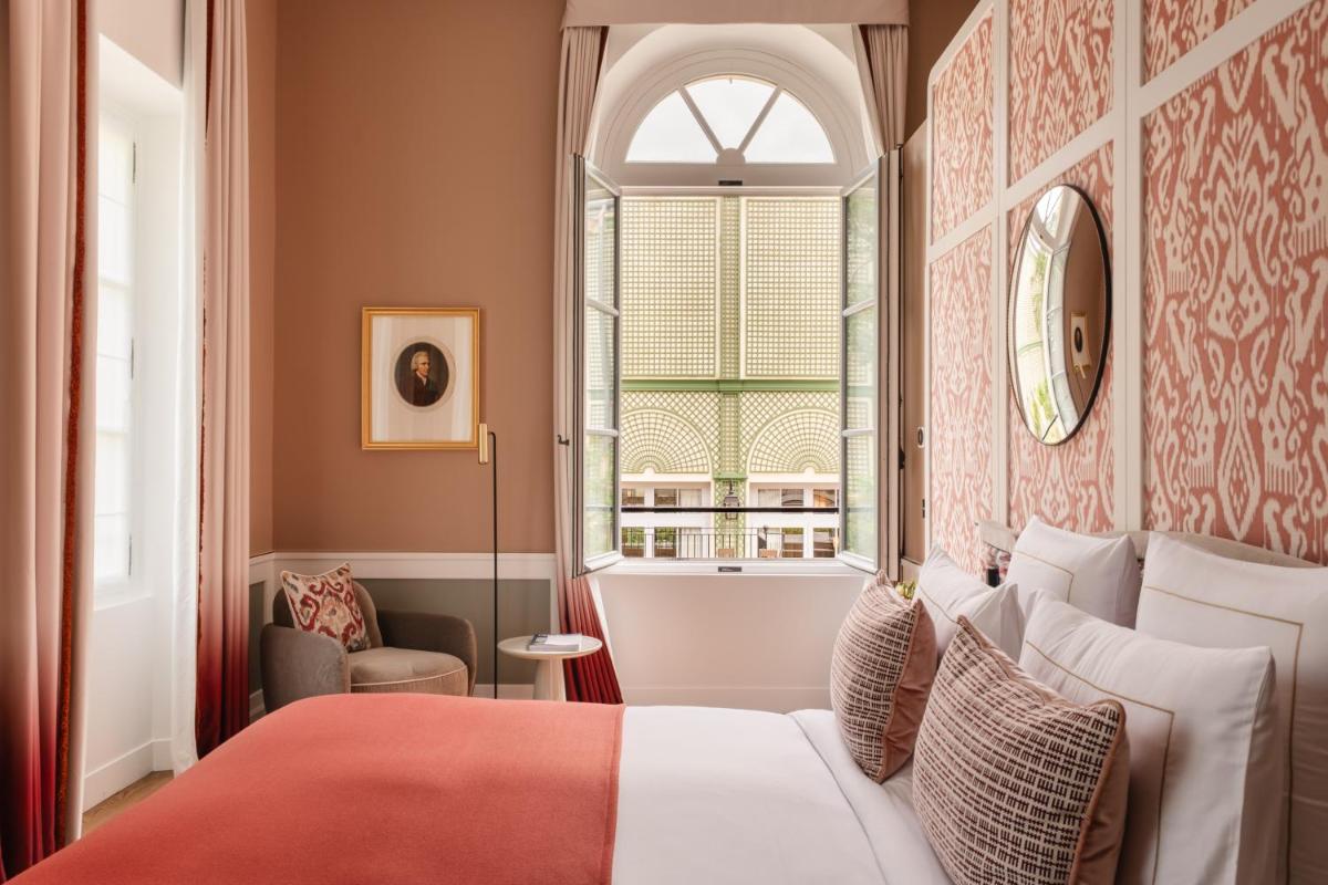 Un ou plusieurs lits dans un hébergement de l'établissement Hôtel Les Lumières - Relais & Châteaux