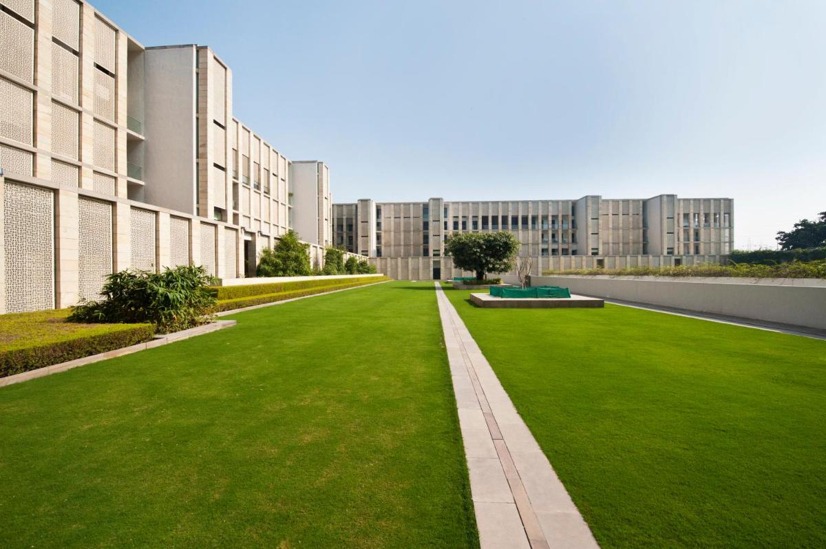 a green lawn in front of a building at The Lodhi – A member of The Leading Hotels Of The World in New Delhi