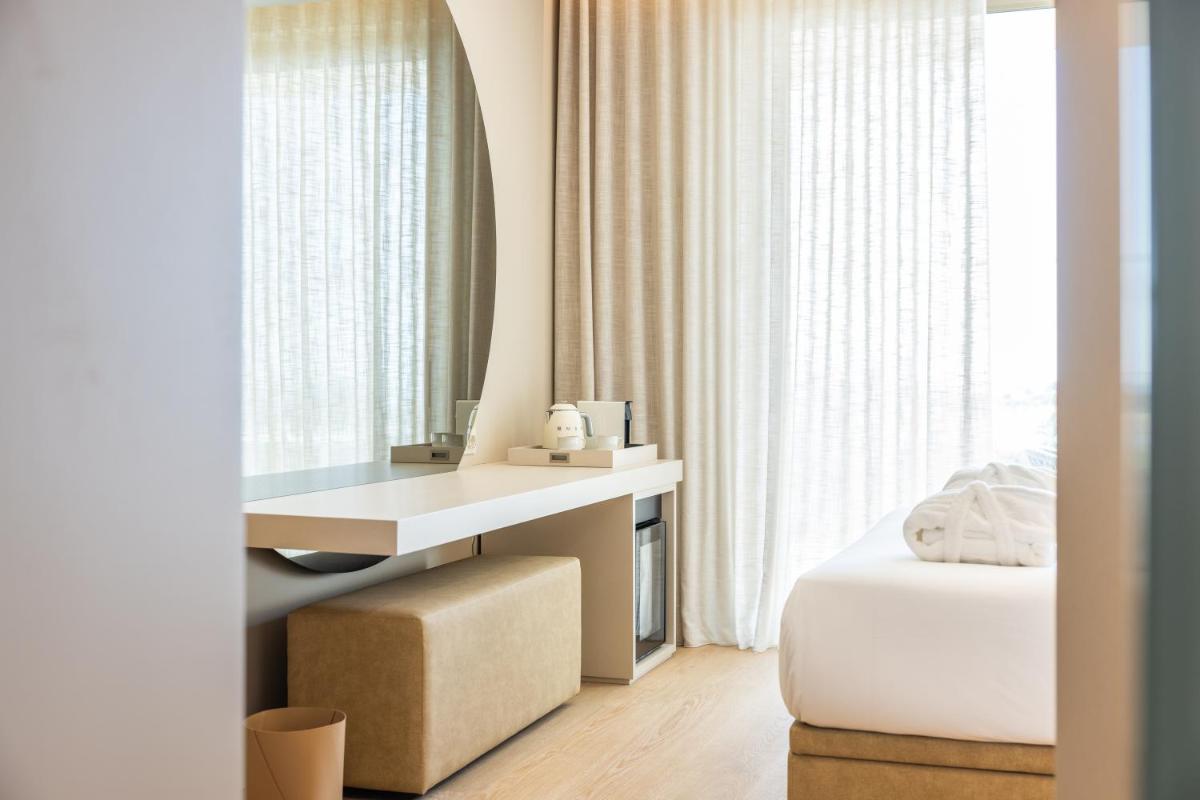 Uma cama ou camas num quarto em Castelo Suites Hotel
