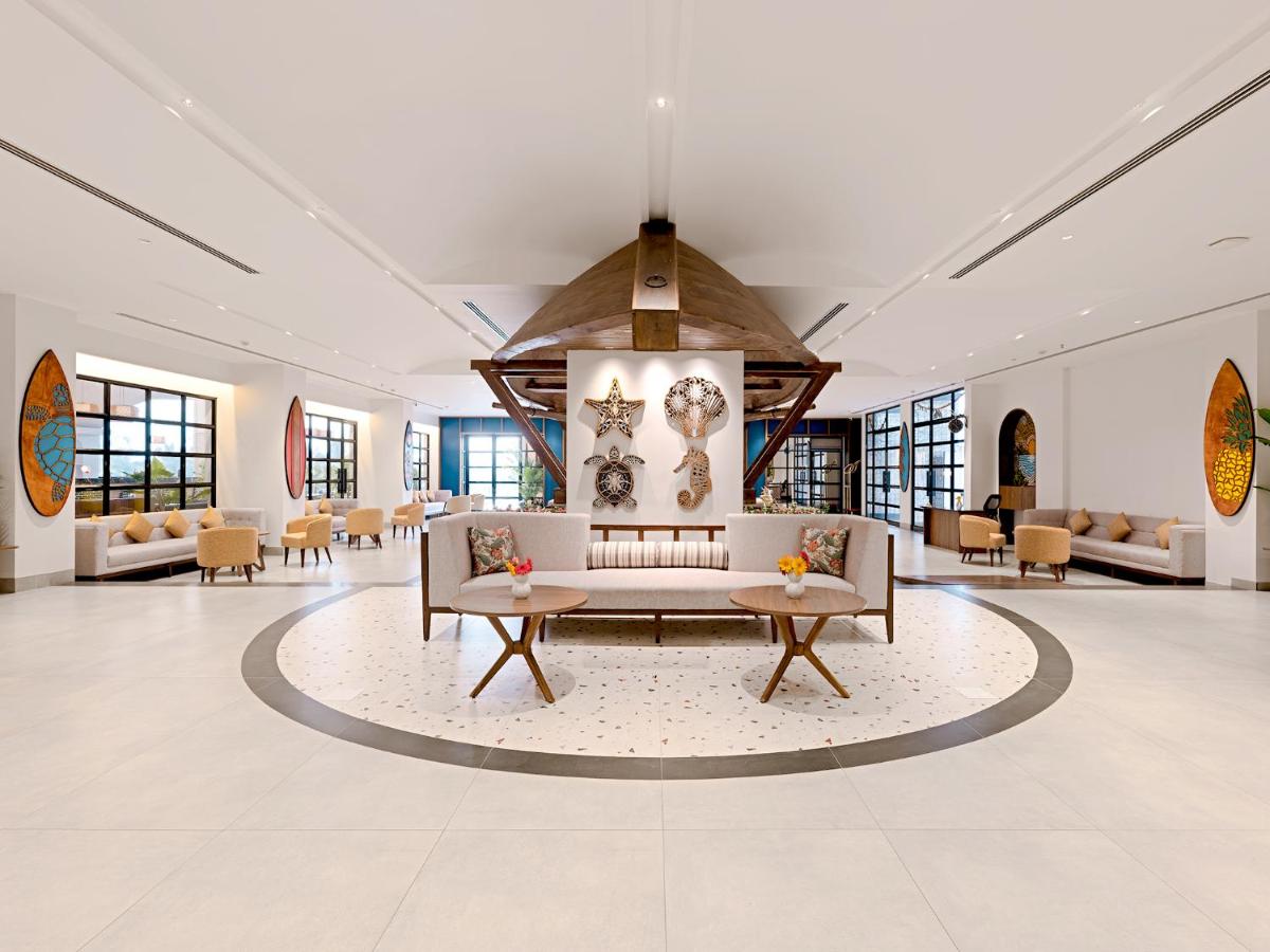a lobby with couches and tables in a building at Gateway Goa, Palolem in Palolem