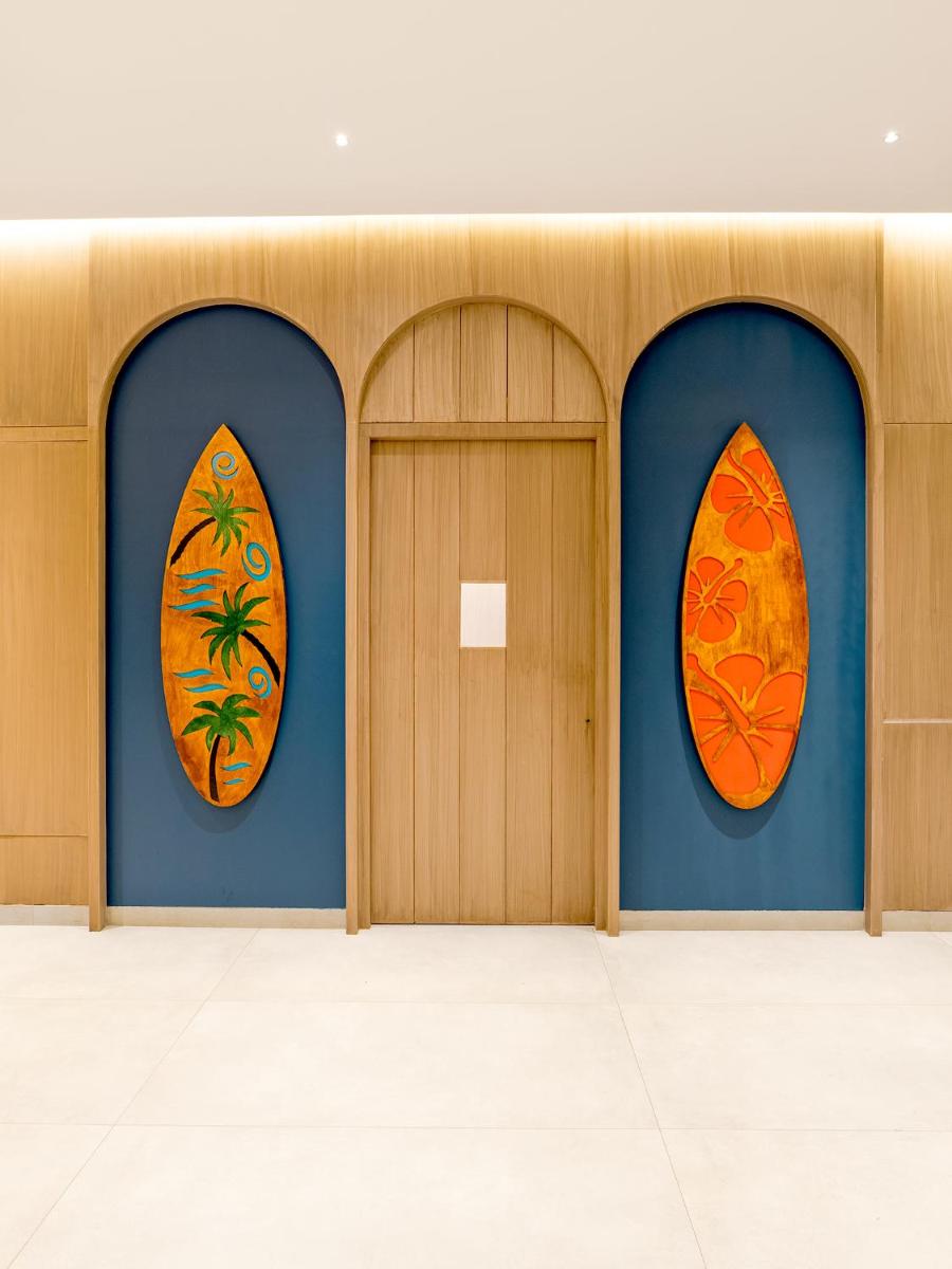 three surfboards on the wall in a room at Gateway Goa, Palolem in Palolem