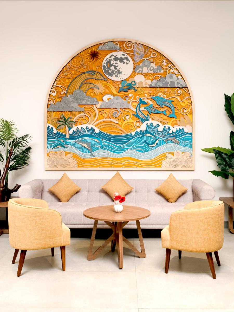 a living room with a couch and a large painting at Gateway Goa, Palolem in Palolem
