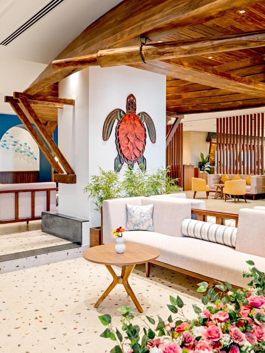 a living room with a turtle mural on the wall at Gateway Goa, Palolem in Palolem