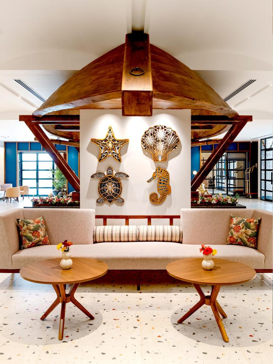 a living room with a couch and two tables at Gateway Goa, Palolem in Palolem