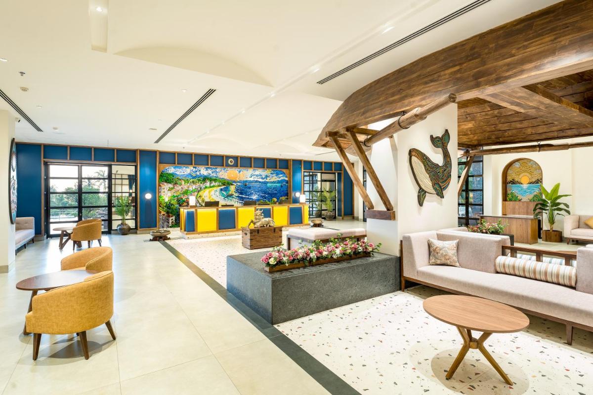 a living room with a couch and tables at Gateway Goa, Palolem in Palolem