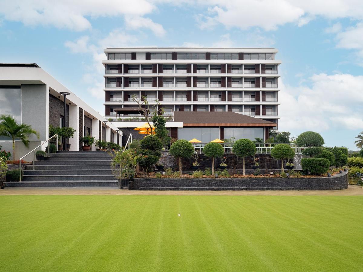 a building with a green lawn in front of it at Gateway Goa, Palolem in Palolem