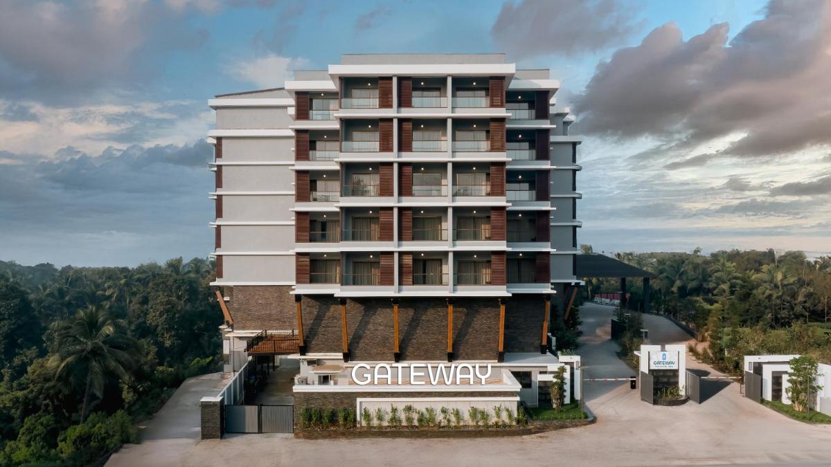 a tall white building with a sign on it at Gateway Goa, Palolem in Palolem