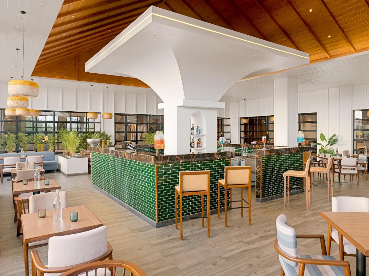 a restaurant with tables and chairs and a bar at Gateway Goa, Palolem in Palolem