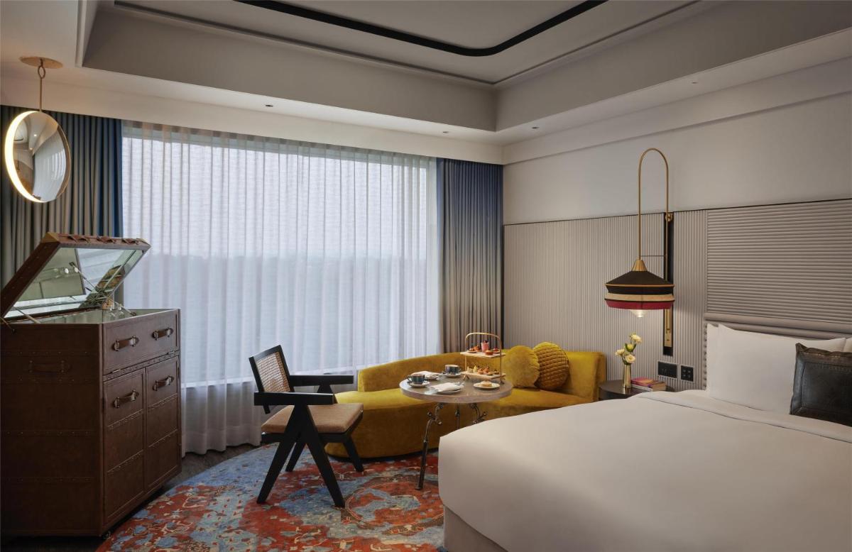 a hotel room with a bed and a couch at Hyatt Centric Sector17 Chandigarh in Chandīgarh
