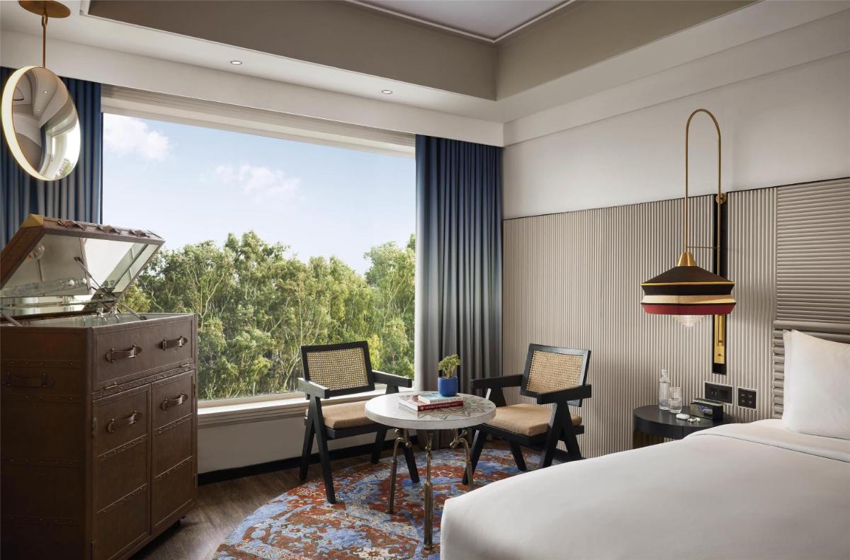 a hotel room with a bed and a table and a window at Hyatt Centric Sector17 Chandigarh in Chandīgarh