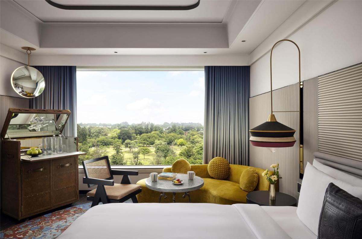a hotel room with a bed and a large window at Hyatt Centric Sector17 Chandigarh in Chandīgarh
