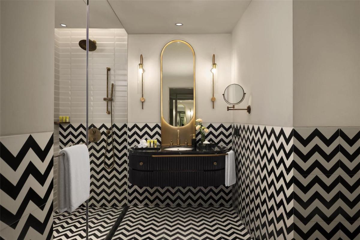 a bathroom with a black and white checkered floor at Hyatt Centric Sector17 Chandigarh in Chandīgarh