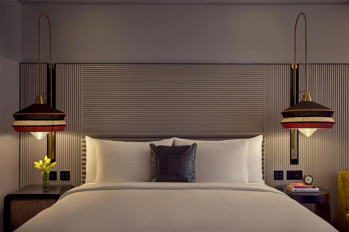 a bedroom with a large white bed with two lamps at Hyatt Centric Sector17 Chandigarh in Chandīgarh