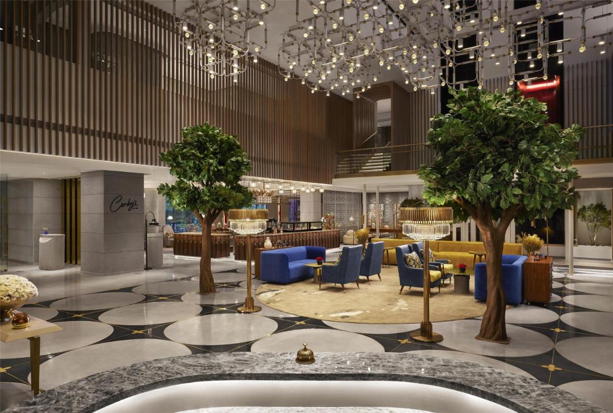 a rendering of a lobby with trees and chairs at Hyatt Centric Sector17 Chandigarh in Chandīgarh